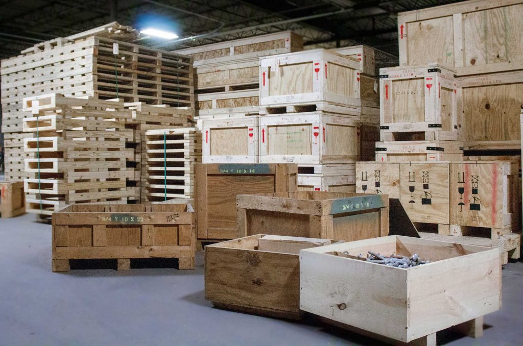 Assortment of wooden crates and pallets stacked in a warehouse 2000 X 1324